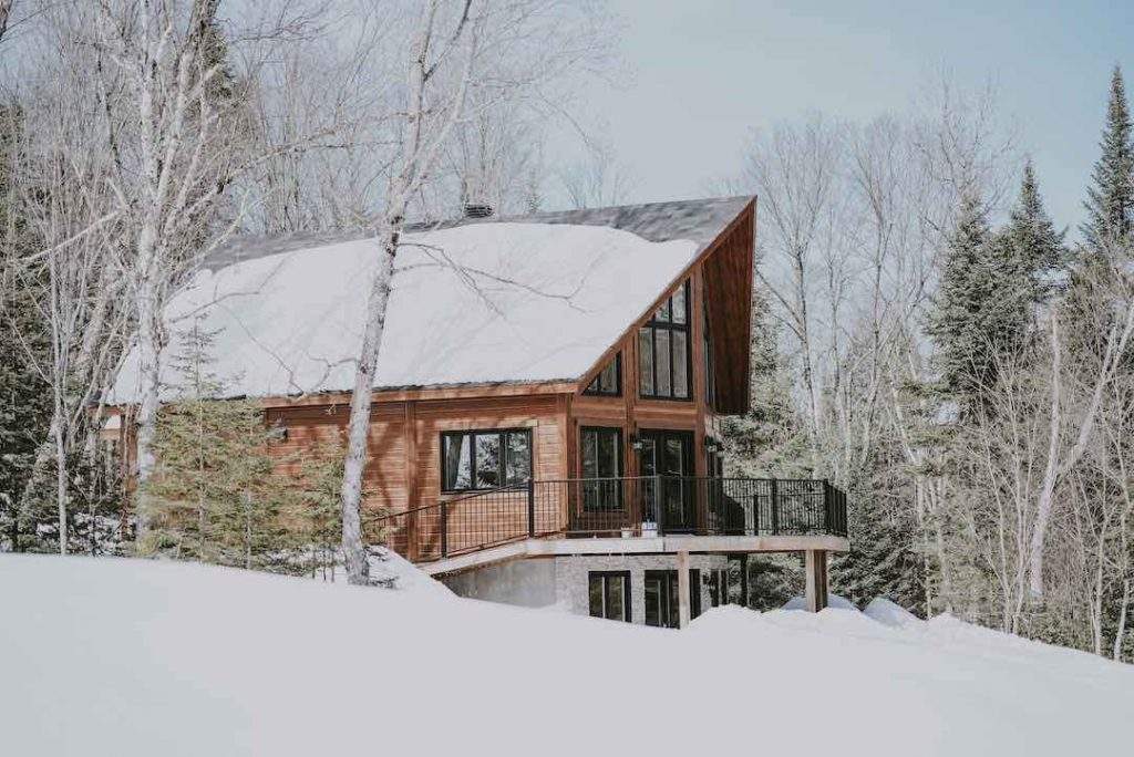 an Ottawa house in winter with lots of snow on the roof